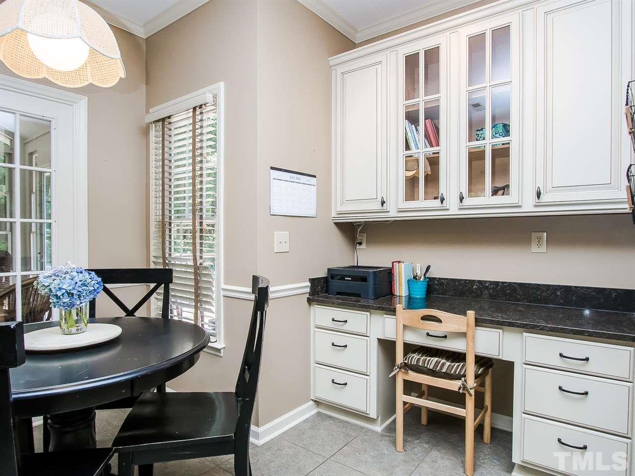 3400 Ribcowski Court Raleigh, NC 27616 - Photo 9 of 25 a kitchen with granite countertop a stove a table and chairs