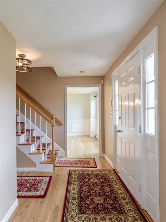 15 Mansfield Road Middleton, MA 01949 - Photo 15 of 42 a view of a hallway with wooden floor and windows