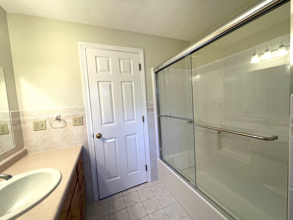 15 Mansfield Road Middleton, MA 01949 - Photo 18 of 42 a bathroom with a granite countertop shower a sink and a bathtub