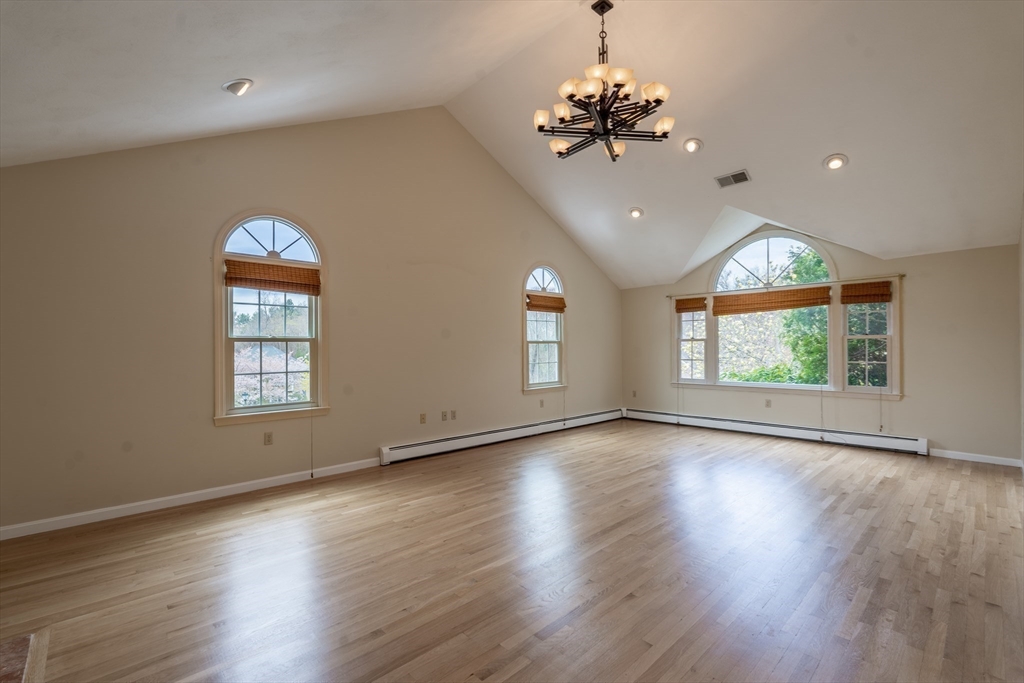 15 Mansfield Road Middleton, MA 01949 - Photo 8 of 42 a view of an empty room with wooden floor and a window