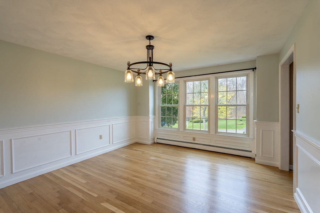 15 Mansfield Road Middleton, MA 01949 - Photo 9 of 42 a view of an empty room with wooden floor and a window
