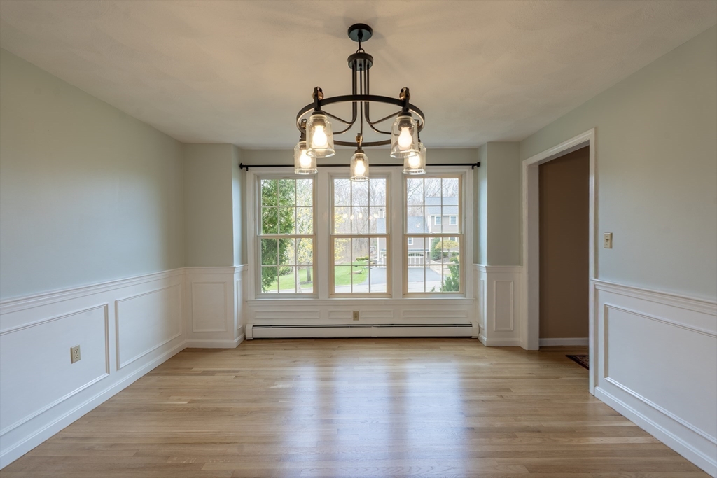 15 Mansfield Road Middleton, MA 01949 - Photo 10 of 42 a view of an empty room with wooden floor and a window