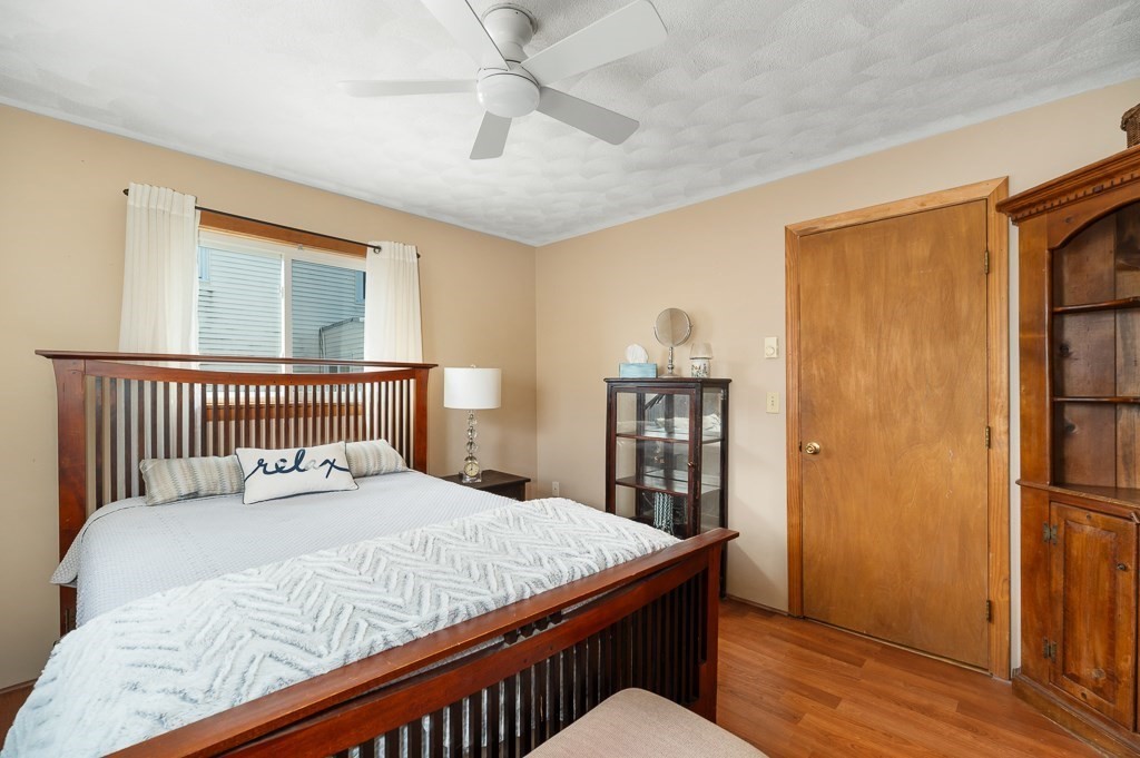 9 Alpine Court Gloucester, MA 01930 - Photo 23 of 32 a bedroom with a bed and wooden floor