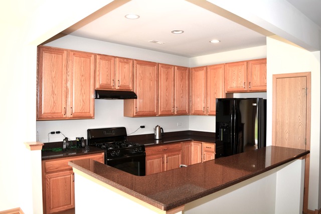 13631 Hemlock Road Huntley, IL 60142 - Photo 5 of 12 a kitchen with granite countertop a refrigerator and a sink