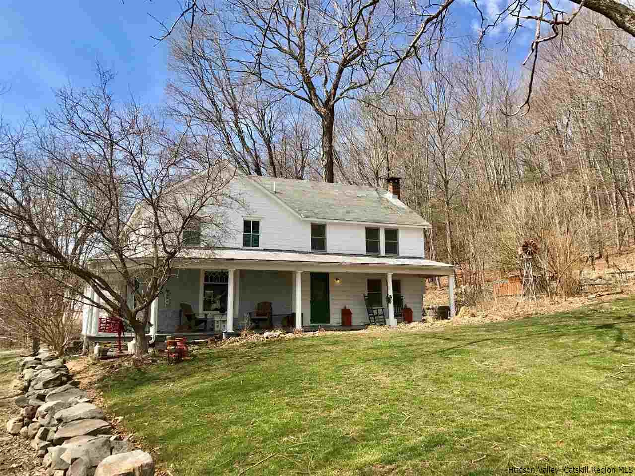 45 Upper Whitfield Road Accord, NY 12404 - Photo 2 of 18 a front view of a house with a garden and trees