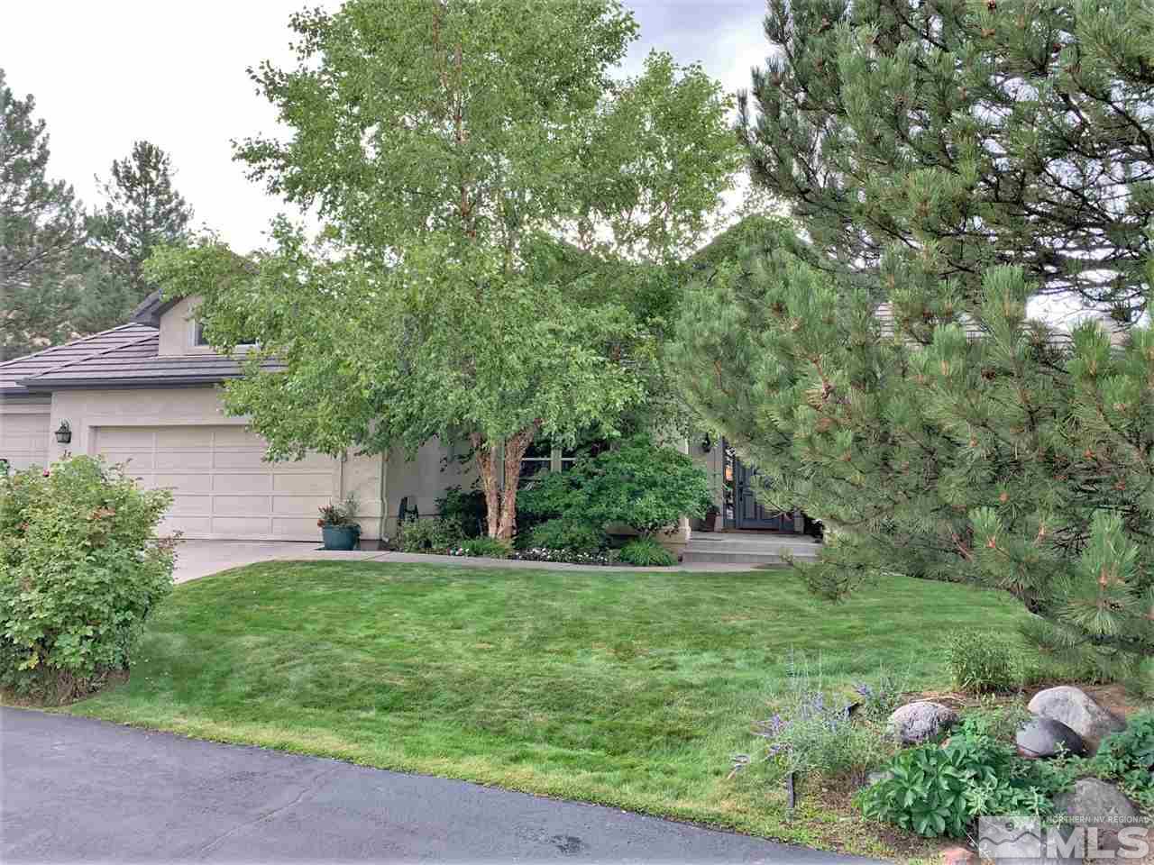 27 Sawbuck Road Reno, NV 89519 - Photo 1 of 1 a backyard of a house with plants and large tree
