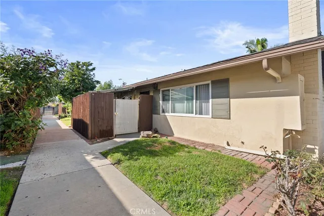a view of backyard with potted plants and a garage