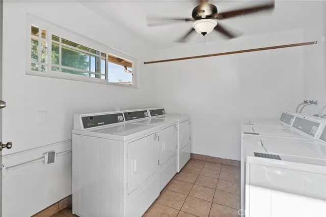 a utility room with cabinets washer and dryer