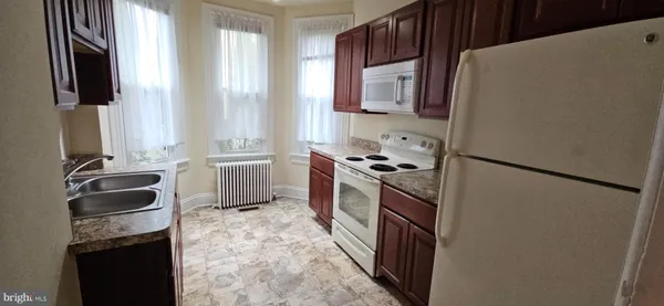 a kitchen with a refrigerator stove and sink