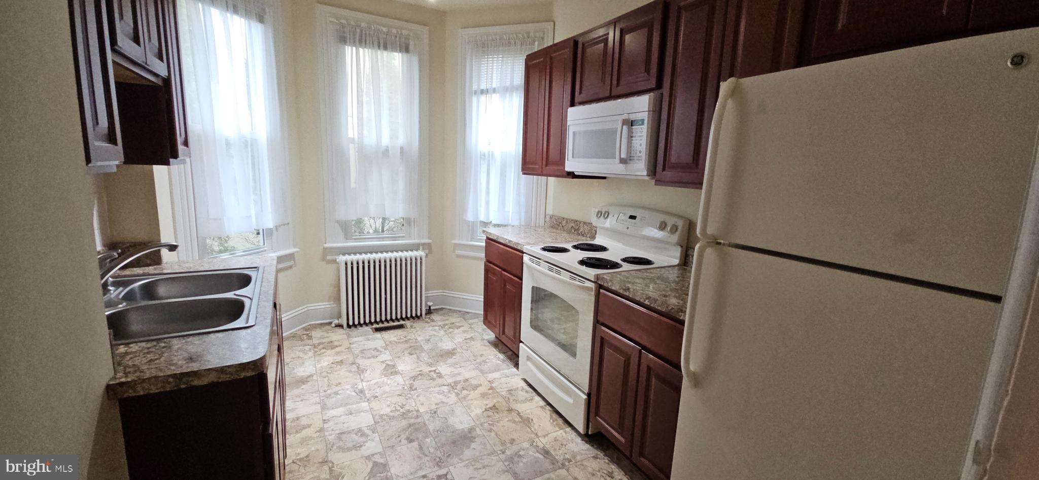 434 Fairmont Avenue, Unit 1 Winchester, VA 22601 - Photo 14 of 15 a kitchen with a refrigerator stove and sink