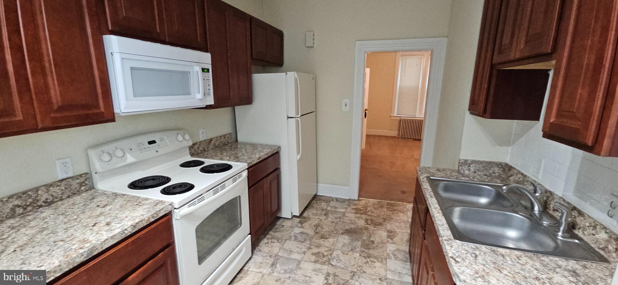 434 Fairmont Avenue, Unit 1 Winchester, VA 22601 - Photo 15 of 15 a kitchen with a sink stove and refrigerator