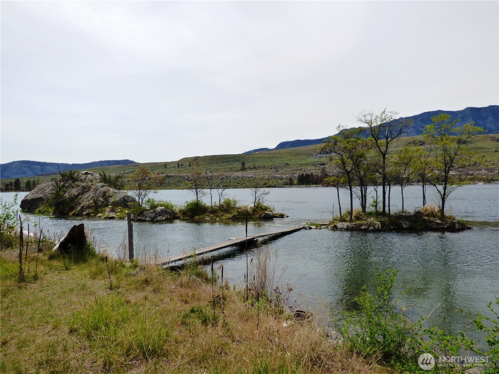 0 Bailey Way Brewster, WA 98812 - Photo 10 of 17 a view of a lake with mountains in the back