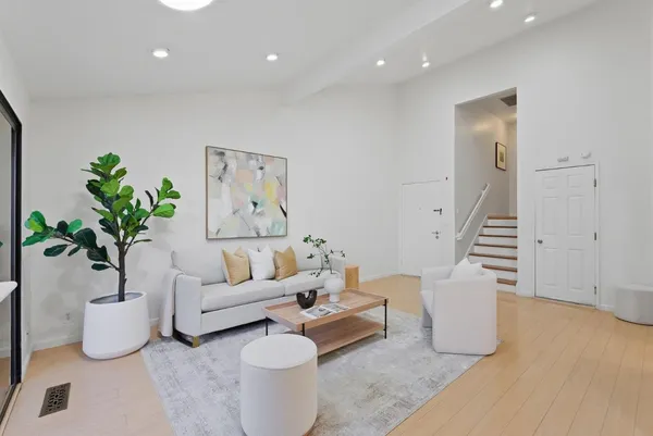 a living room with furniture and a potted plant