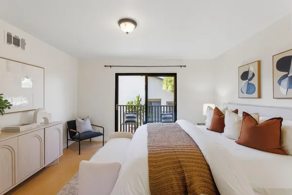 a bedroom with a large bed and a large window