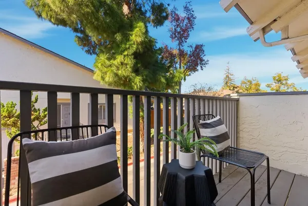 a view of a balcony with chairs