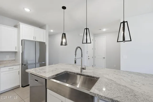 a kitchen with a sink and a refrigerator
