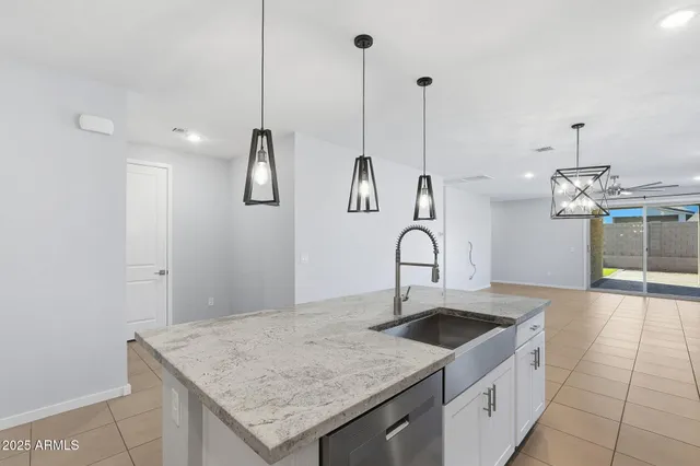 a kitchen with a sink a counter space and cabinets