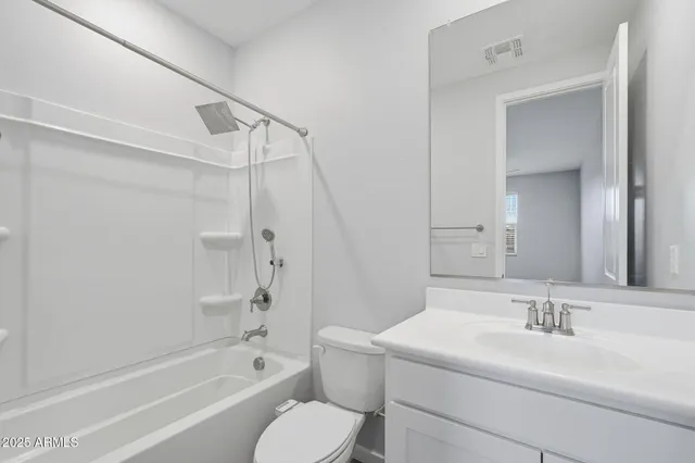 a bathroom with a sink toilet vanity and shower