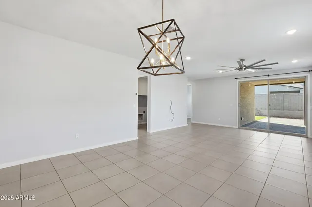 a view of hallway with a window and a chandelier