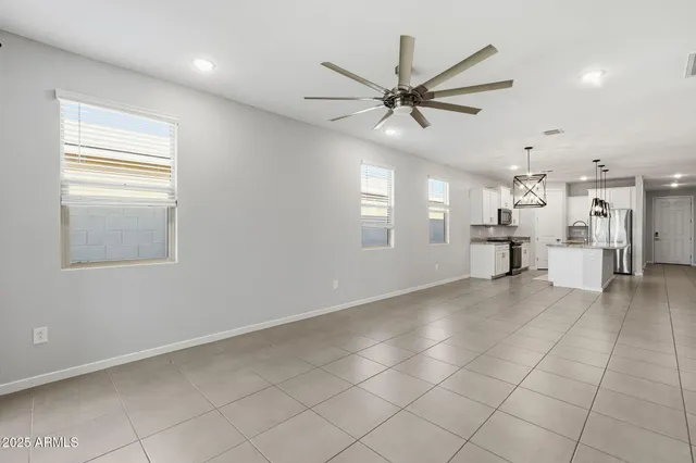 a view of a livingroom with a ceiling fan and window