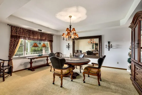 a living room with furniture and a chandelier
