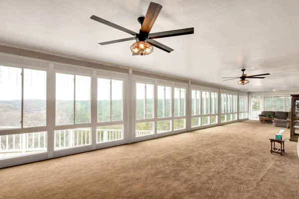 a view of a livingroom with furniture and a ceiling fan