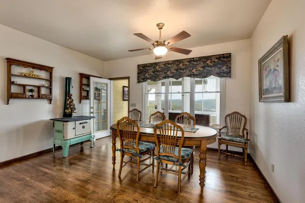 a view of a dining room with furniture wooden floor and chandelier