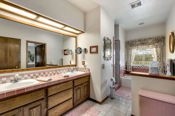 a bathroom with a granite countertop sink a mirror and a toilet