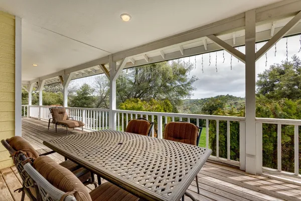 a view of a chairs and table in the balcony