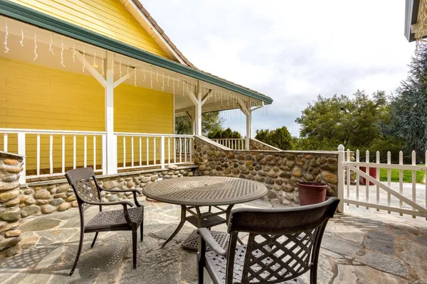 a view of a big house with a big yard and large trees