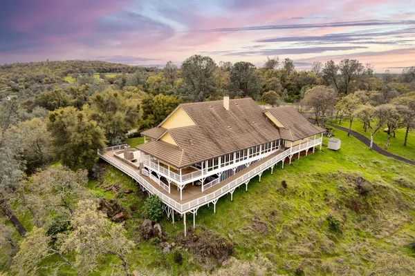 an aerial view of a house with a yard