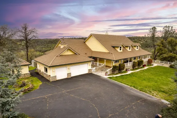 a view of a house with garden and chairs