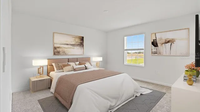 a bedroom with bed and painting on the wall