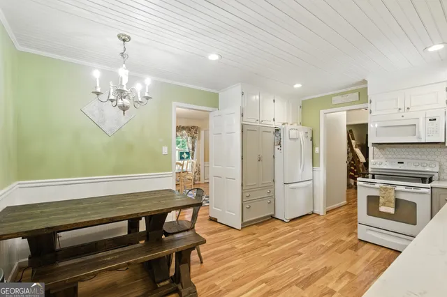 a kitchen with stainless steel appliances a stove a refrigerator and cabinets