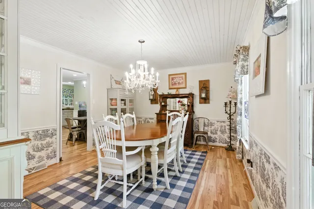 a view of a dining room with furniture and chandelier