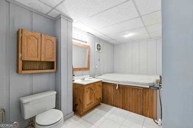 a bathroom with a toilet a sink and mirror