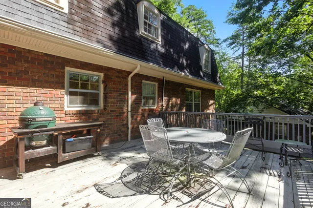 a view of a patio with a table chairs and barbeque