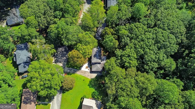 an aerial view of a house with a yard