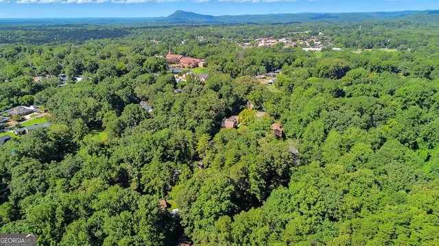 an aerial view of a houses with a yard