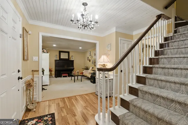 a view of a livingroom with furniture and stairs