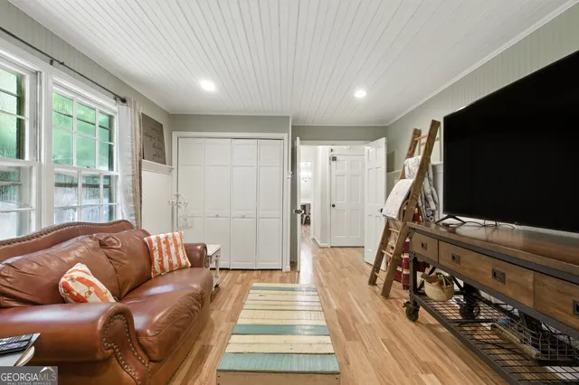a living room with furniture and a flat screen tv