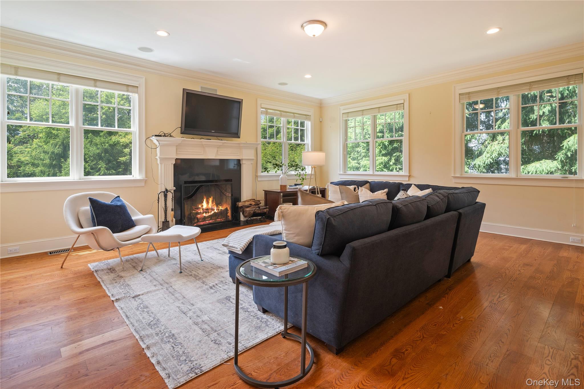 77 Byram Ridge Road Armonk, NY 10504 - Photo 14 of 48 Family room with wood burning fireplace, flat screen tv hookup, crown molding, recessed lighting, wide board oak floors