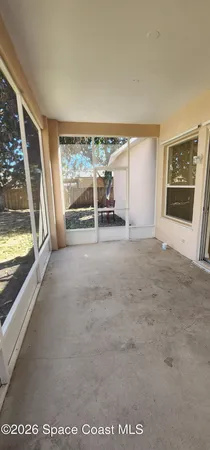 a view of a livingroom with an empty space and a window