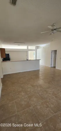 a view of a refrigerator in an empty room
