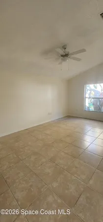 an empty room with a empty space and windows