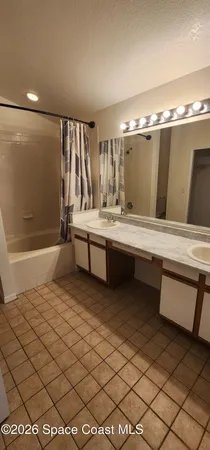a large white room with a large mirror and sink