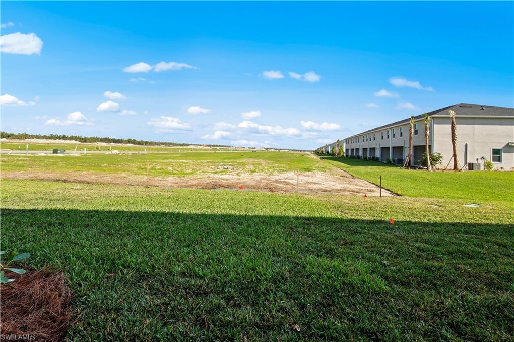 15027 White Pearl Road Babcock Ranch, FL 33982 - Photo 23 of 38 a view of a big swimming pool with an outdoor space and seating area