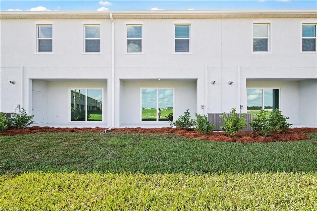 15027 White Pearl Road Babcock Ranch, FL 33982 - Photo 24 of 38 a front view of a house with a yard