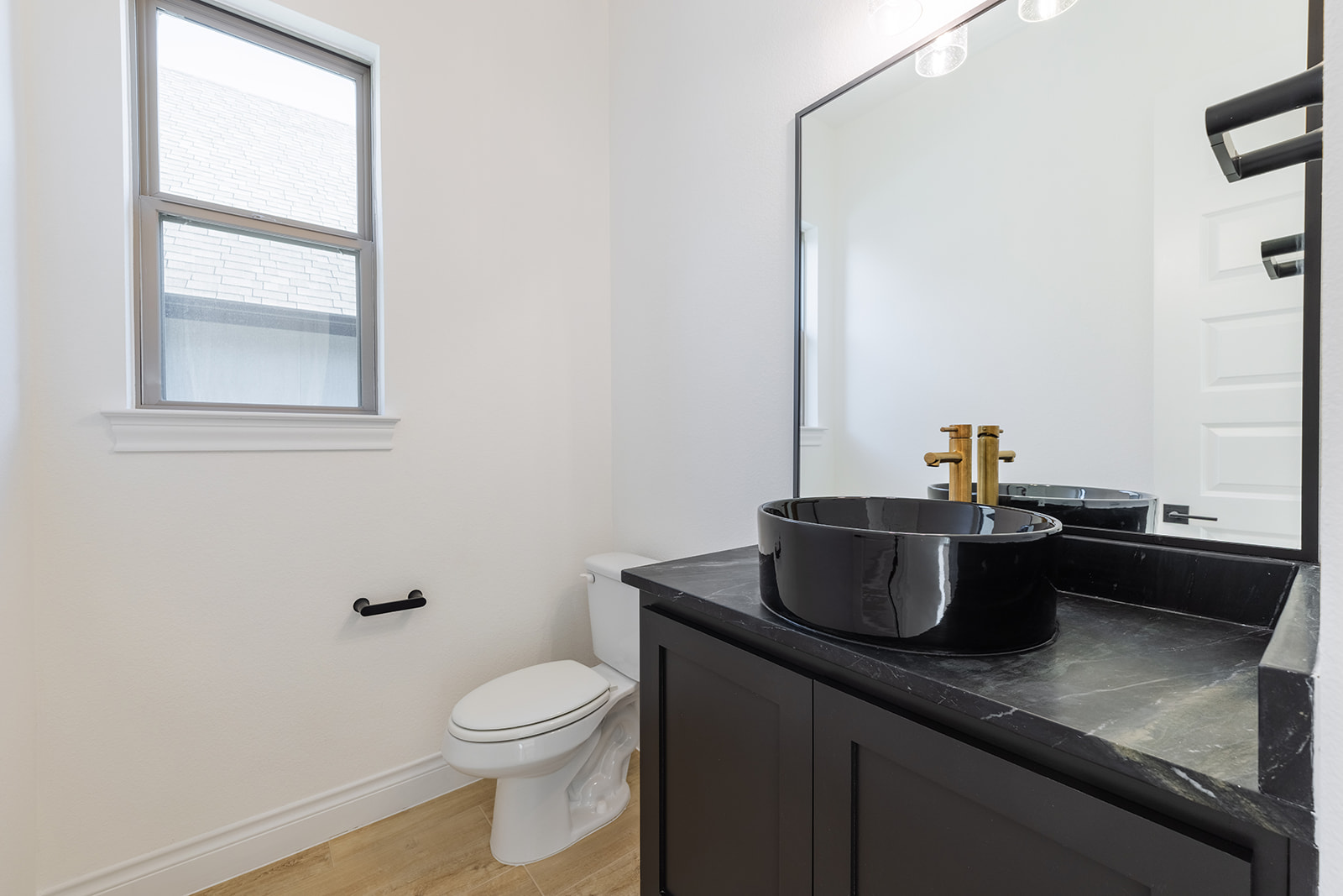 109 Strawberry Lane Georgetown, TX 78628 - Photo 24 of 40 a bathroom with a granite countertop sink toilet and a mirror
