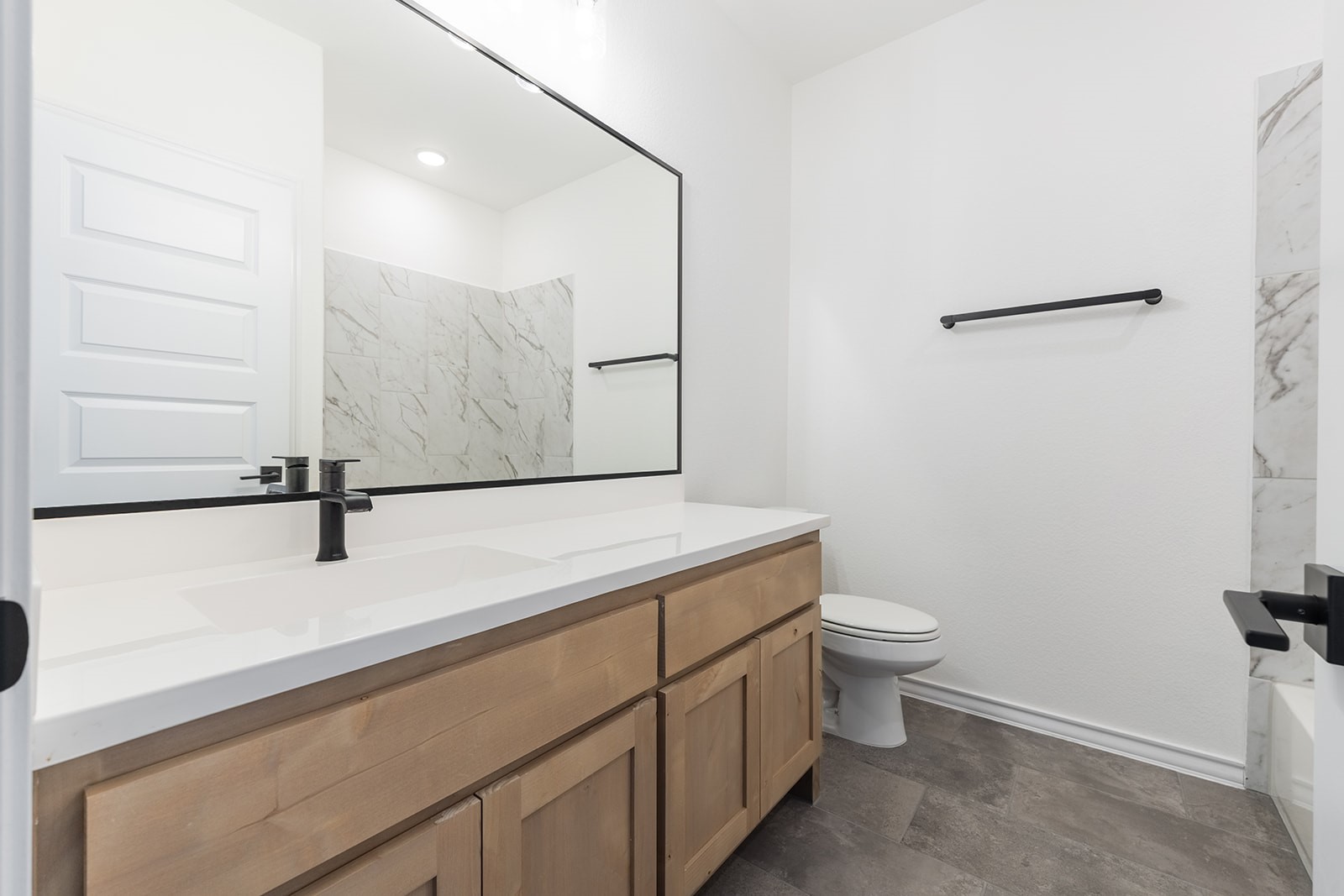 109 Strawberry Lane Georgetown, TX 78628 - Photo 30 of 40 a bathroom with a granite countertop sink a toilet and a mirror